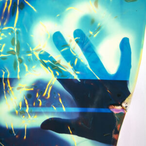detail of Ellen Carey's photograph, outline of hand on blue background